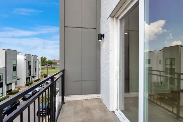 a view of a balcony with furniture and city view