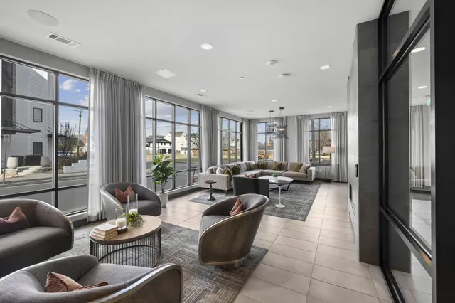 a living room with furniture a rug and a chandelier