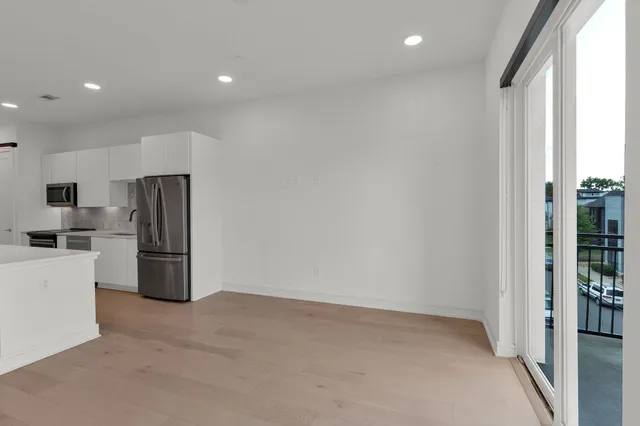 a kitchen with refrigerator and cabinets