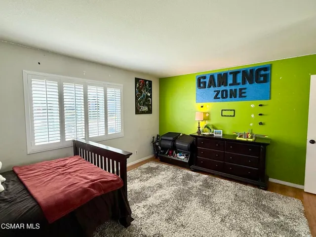 a bedroom with furniture and a rug