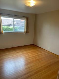 869 Crestview Drive Millbrae, CA 94030 - Photo 8 of 14 an empty room with wooden floor and windows