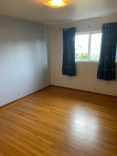 869 Crestview Drive Millbrae, CA 94030 - Photo 9 of 14 an empty room with wooden floor and windows