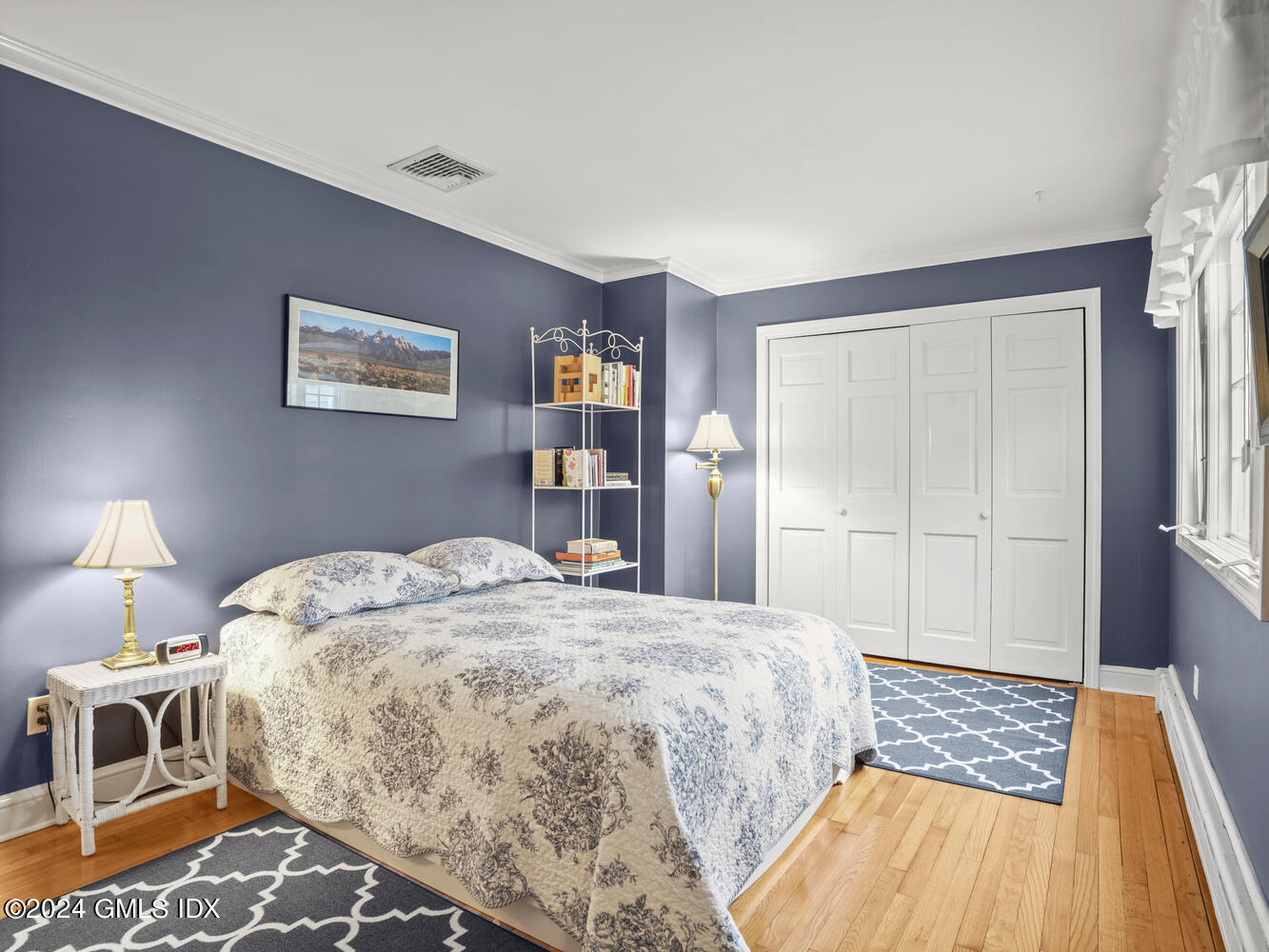 191 Cat Rock Road Cos Cob, CT 06807 - Photo 12 of 30 a bedroom with a bed and a lamp on dresser