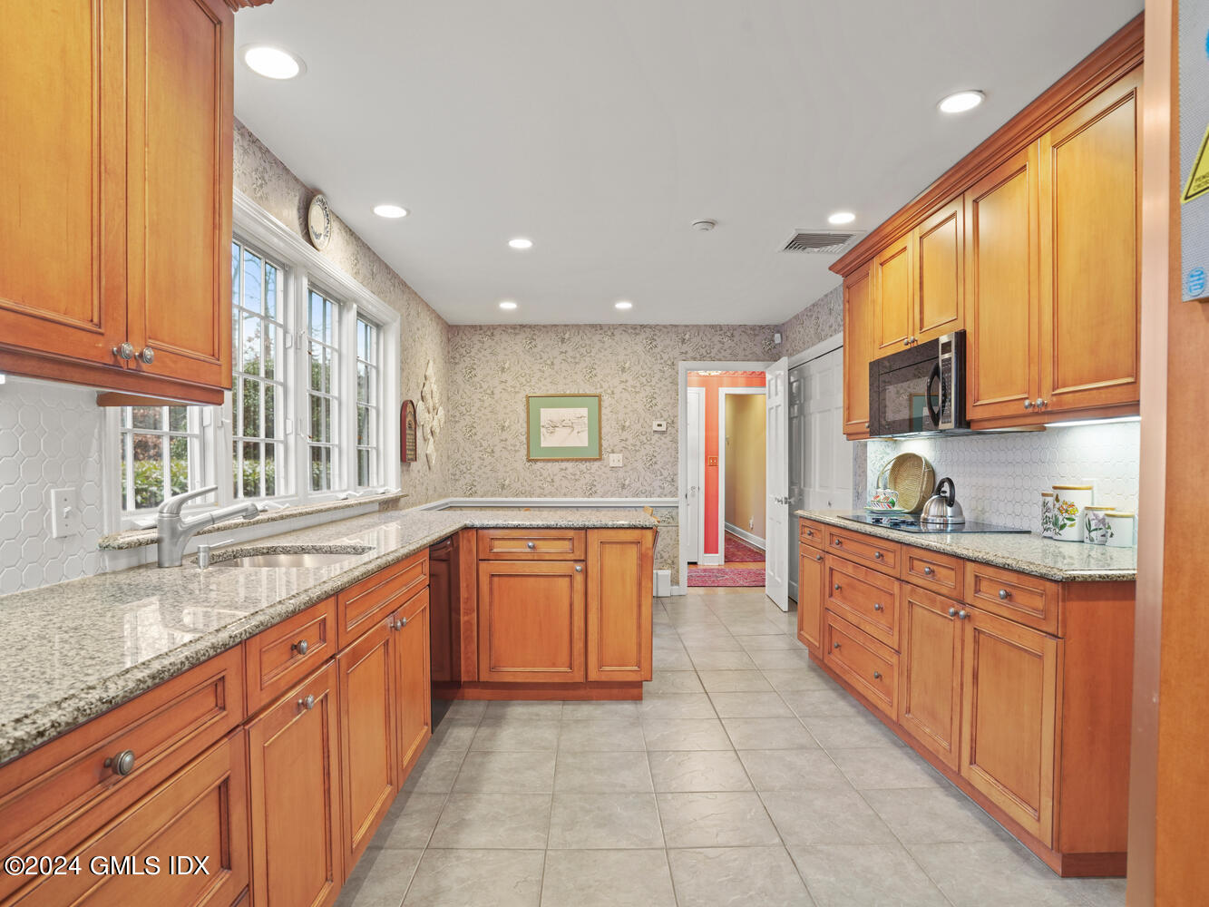 191 Cat Rock Road Cos Cob, CT 06807 - Photo 21 of 30 a large kitchen with stainless steel appliances granite countertop a sink and cabinets