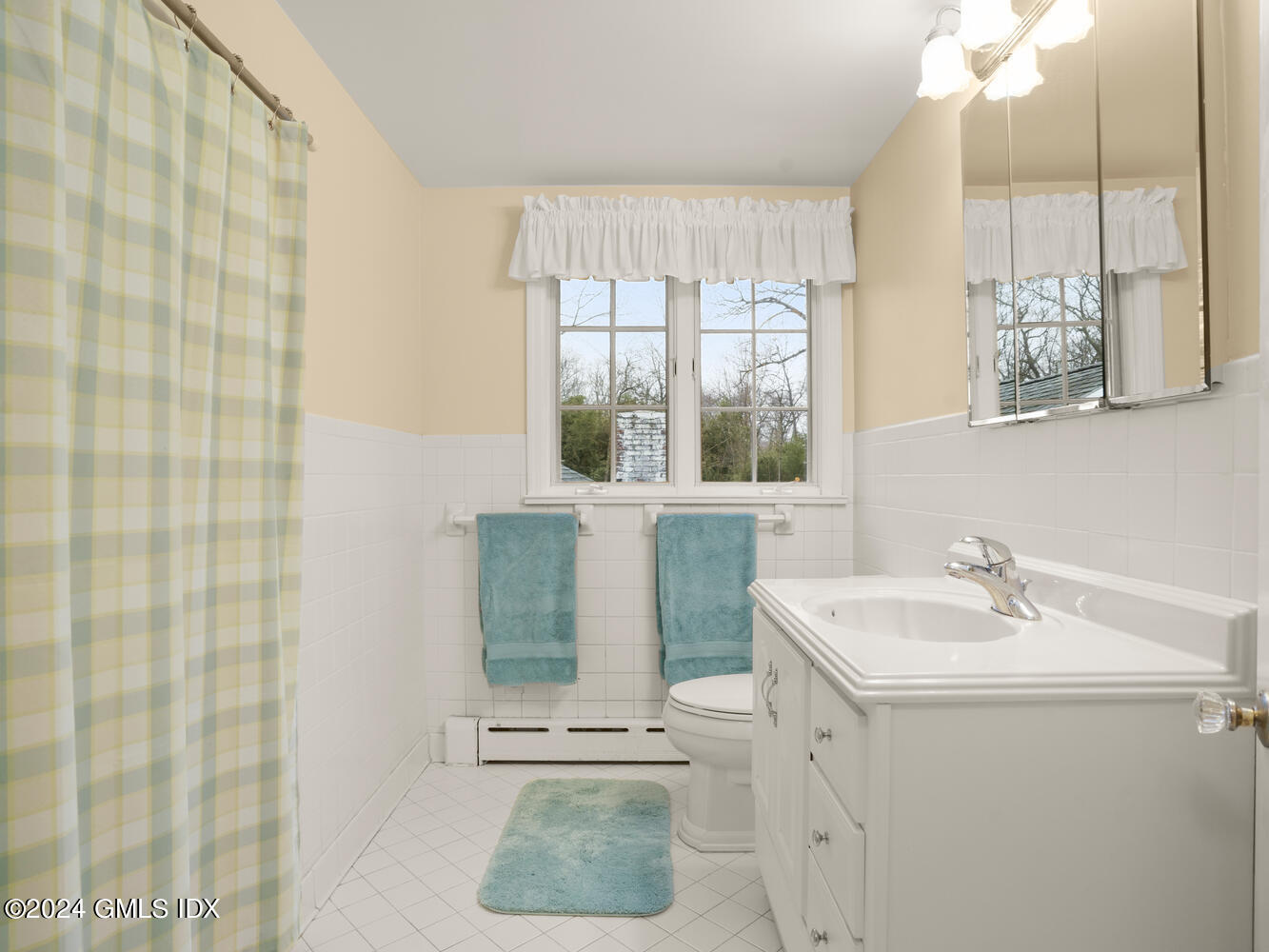 191 Cat Rock Road Cos Cob, CT 06807 - Photo 22 of 30 a bathroom with a sink a mirror and a shower