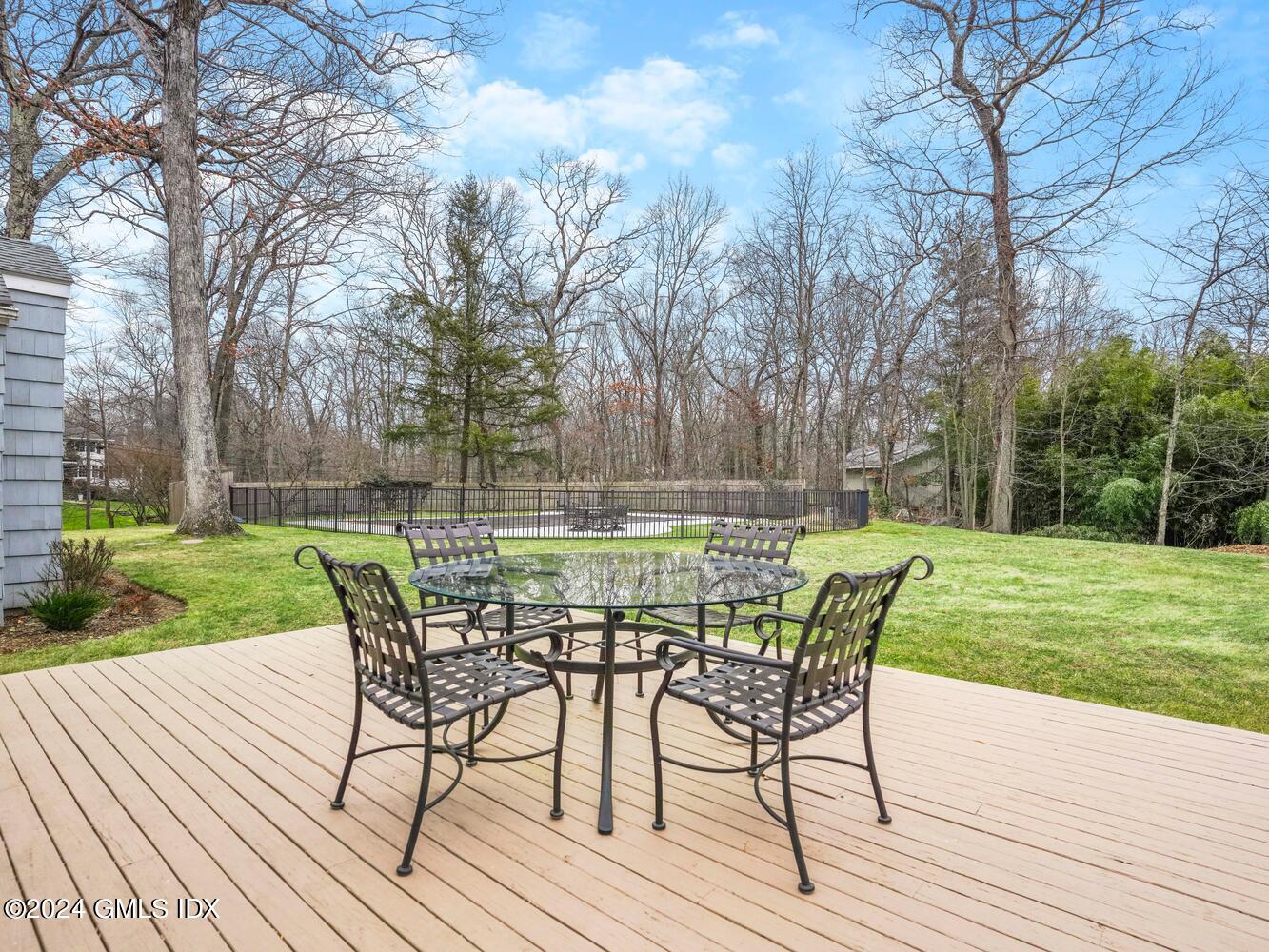 191 Cat Rock Road Cos Cob, CT 06807 - Photo 25 of 30 a view of a table and chairs on the wooden deck