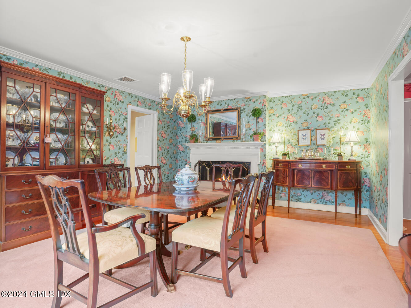 191 Cat Rock Road Cos Cob, CT 06807 - Photo 8 of 30 a view of a dining room with furniture wooden floor and chandelier
