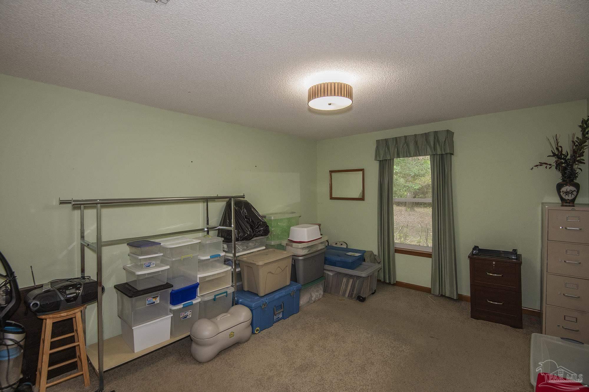 1210 Goldenrod Road Cantonment, FL 32533 - Photo 26 of 50 a bedroom with bed and a window