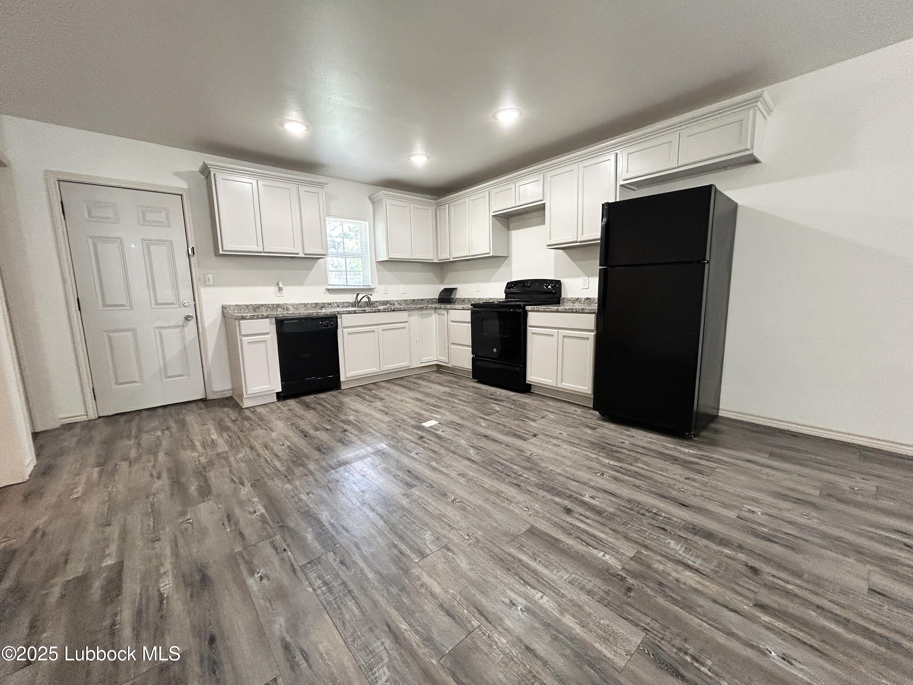 1912 21st Street Lubbock, TX 79411 - Photo 3 of 9 a large kitchen with stainless steel appliances granite countertop a refrigerator and a sink