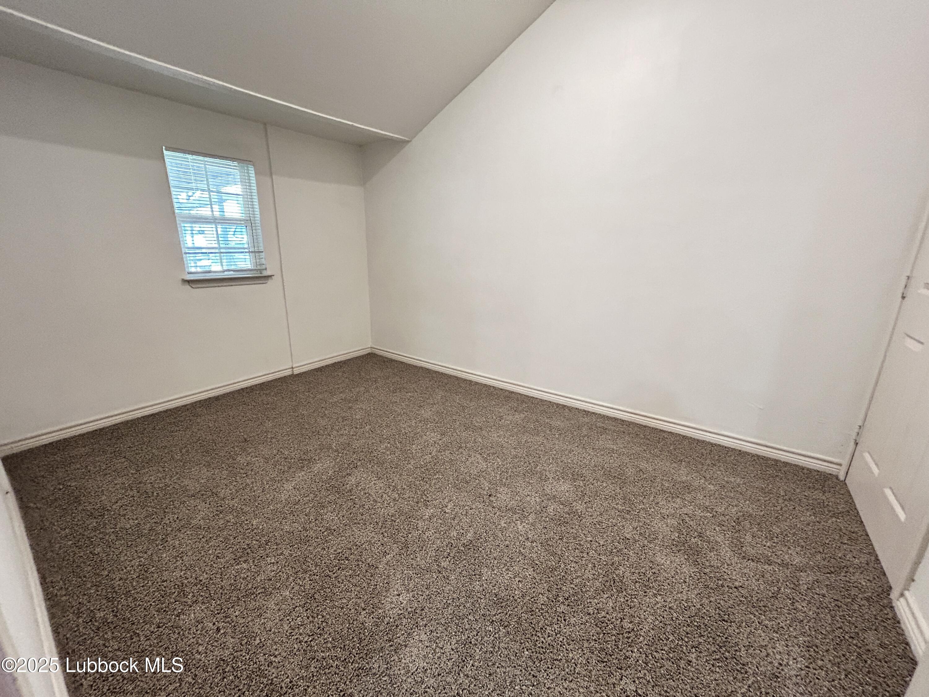 1912 21st Street Lubbock, TX 79411 - Photo 8 of 9 an empty room with windows