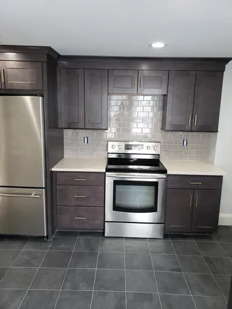 a kitchen with a stove microwave and fridge