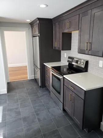a kitchen with a sink a stove and refrigerator