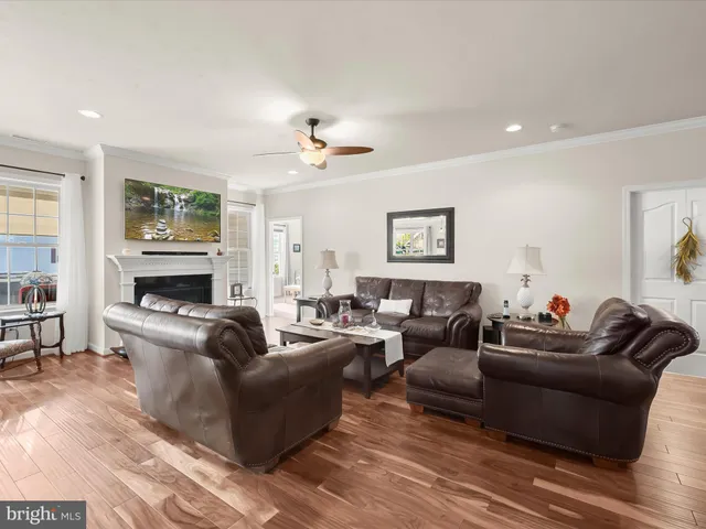 a living room with furniture fireplace and window