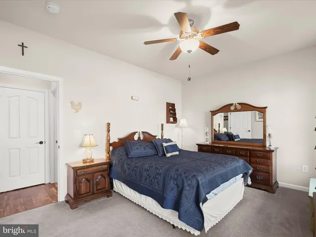 a spacious bedroom with a bed and a dresser