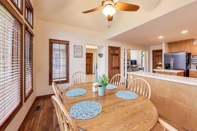 a spacious bathroom with a double vanity sink a mirror and next to a window
