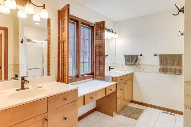 a spacious bedroom with a bed and a chandelier