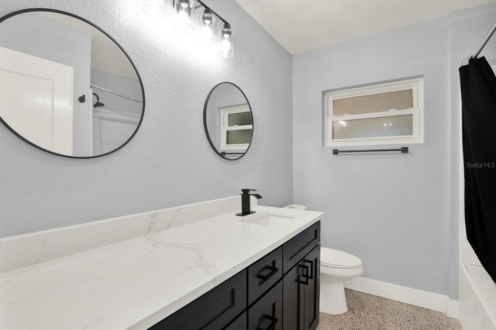 203 163rd Avenue Redington Beach, FL 33708 - Photo 15 of 31 a bathroom with a toilet a sink and mirror