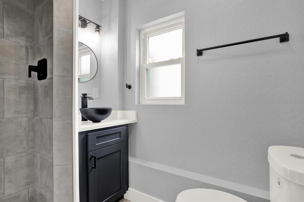 203 163rd Avenue Redington Beach, FL 33708 - Photo 18 of 31 a bathroom with a sink a toilet and shower