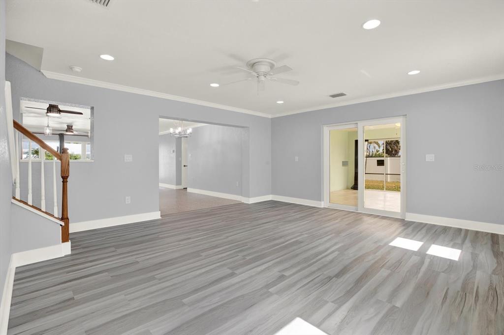 203 163rd Avenue Redington Beach, FL 33708 - Photo 3 of 31 a view of an empty room with wooden floor and a window