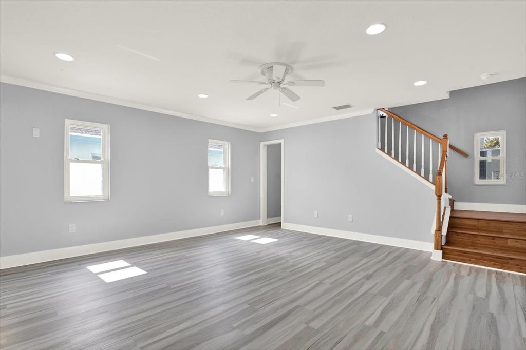203 163rd Avenue Redington Beach, FL 33708 - Photo 4 of 31 a view of an empty room with wooden floor and a window