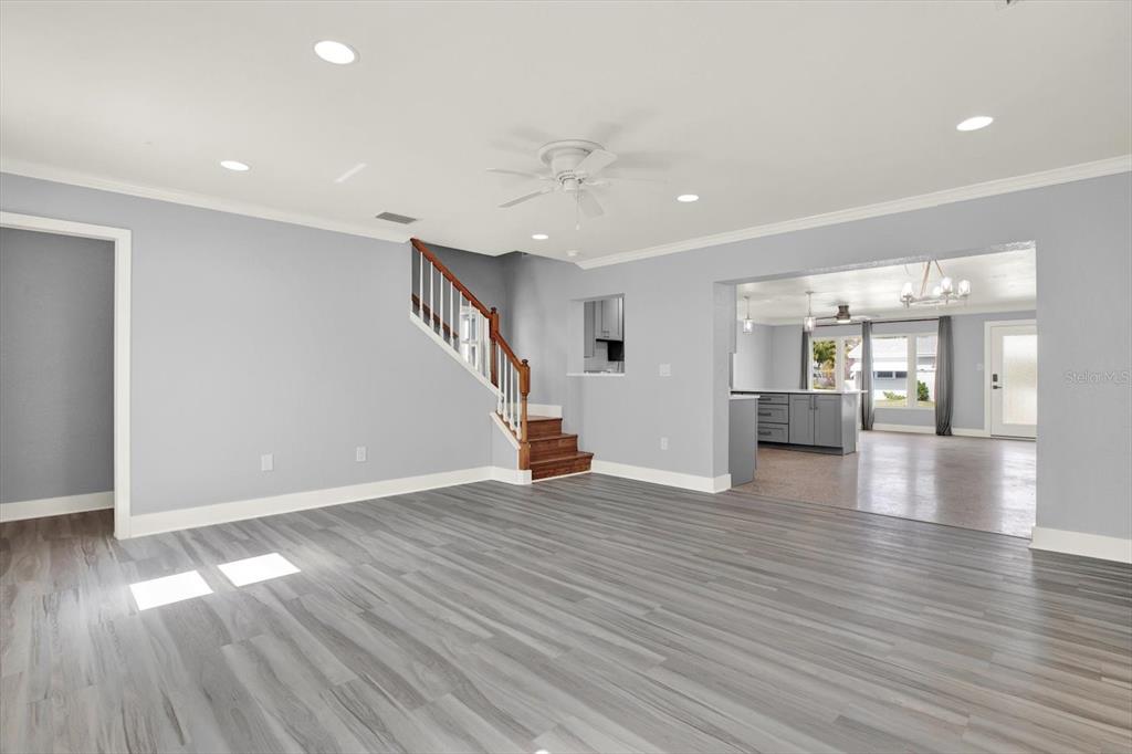 203 163rd Avenue Redington Beach, FL 33708 - Photo 5 of 31 a view of a livingroom with wooden floor and staircase