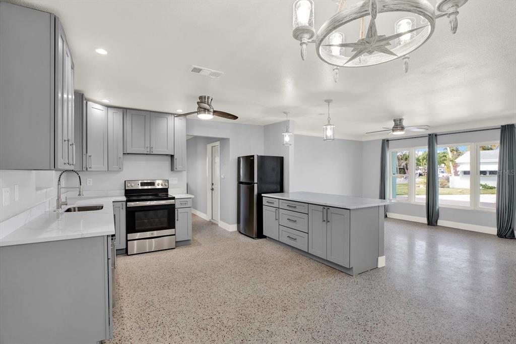 203 163rd Avenue Redington Beach, FL 33708 - Photo 7 of 31 a large kitchen with stainless steel appliances granite countertop a stove oven and a sink with granite countertops