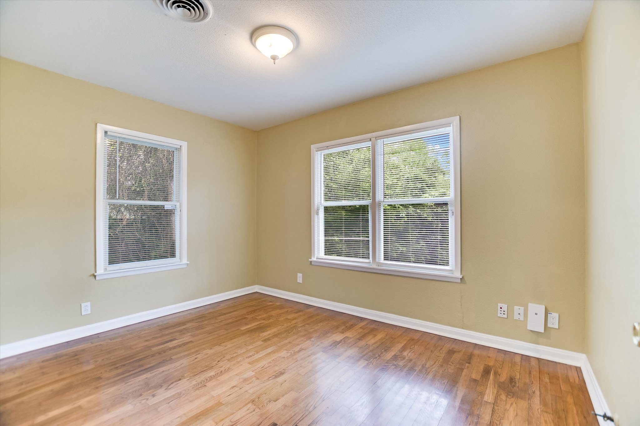 208 Braeswood Road Austin, TX 78704 - Photo 15 of 20 Well-lit room with wood floors awaits your personal touch.