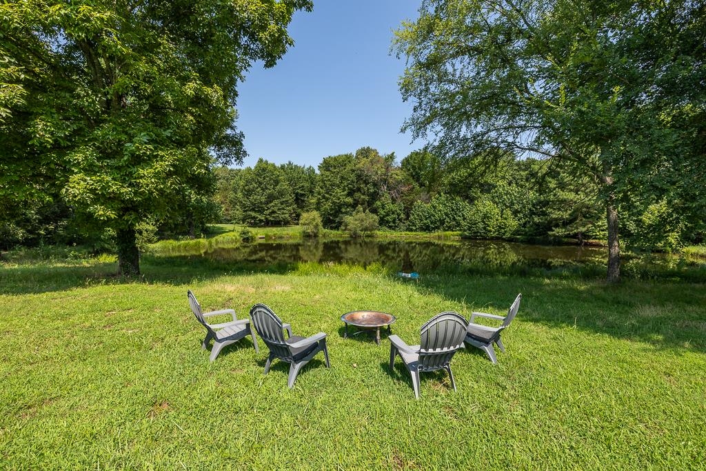 1915 Teague Store Road Somerville, TN 38068 - Photo 5 of 38 Expansive green space featuring a circular fire pit