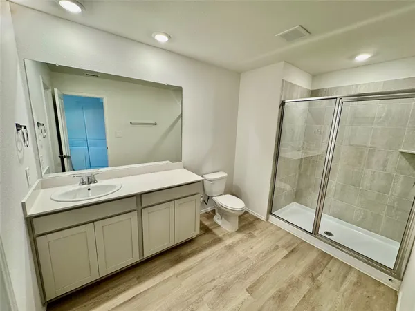 a spacious bathroom with a double vanity sink and a mirror