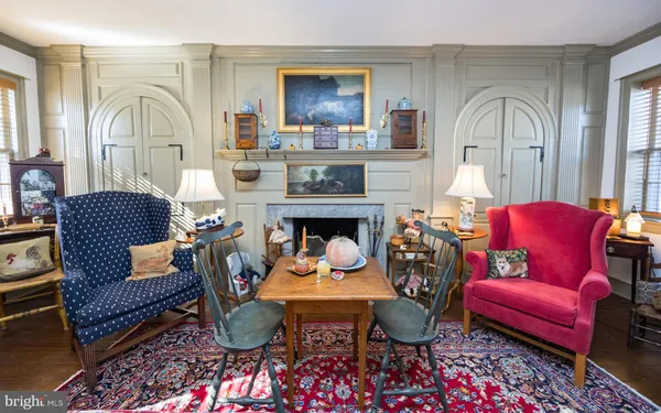 a living room with furniture a fireplace and a rug