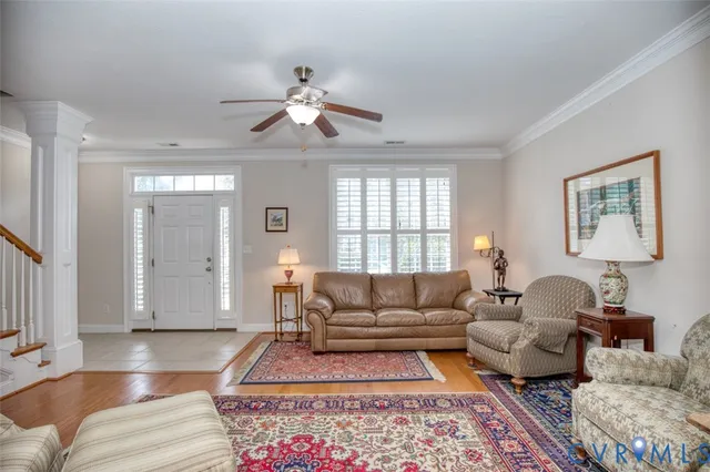 a living room with furniture a rug and a window