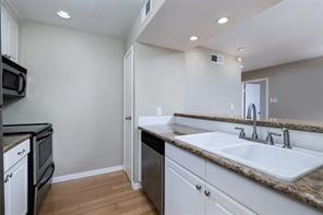 18617 Egret Bay Boulevard, Unit 708 Webster, TX 77058 - Photo 4 of 19 a bathroom with a granite countertop sink and a mirror