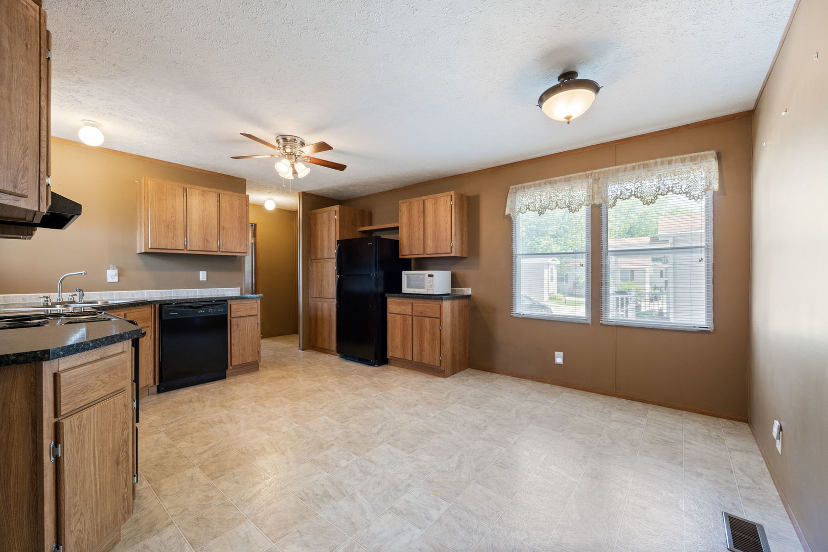 147 Parkwood Road Elgin, IL 60123 - Photo 4 of 16 a open kitchen with granite countertop a refrigerator stove top oven and sink