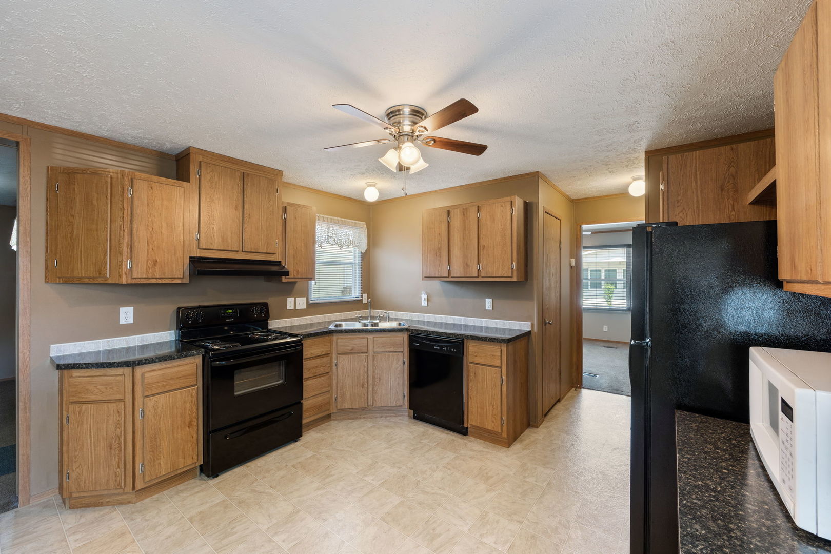 147 Parkwood Road Elgin, IL 60123 - Photo 6 of 16 a kitchen with stainless steel appliances granite countertop a stove sink and refrigerator