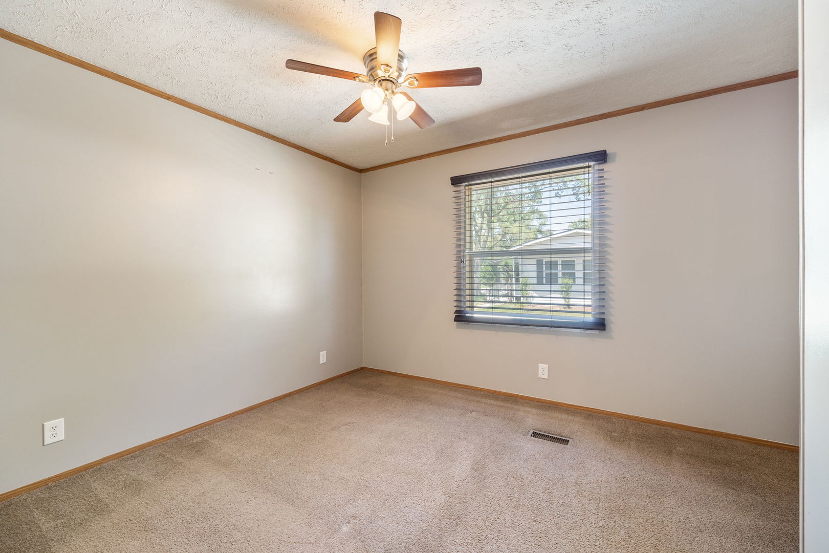 147 Parkwood Road Elgin, IL 60123 - Photo 9 of 16 an empty room with chandelier fan and windows