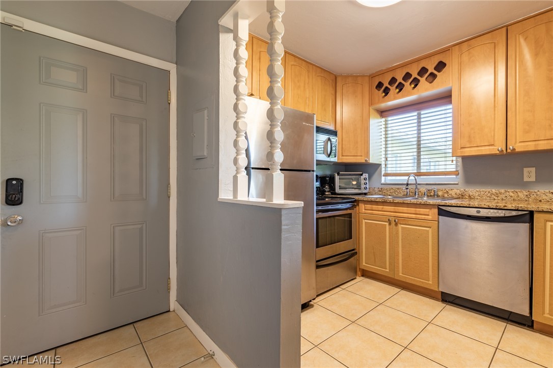 8162 Country Road, Unit 203 Fort Myers, FL 33919 - Photo 1 of 22 a kitchen with granite countertop a refrigerator and a stove