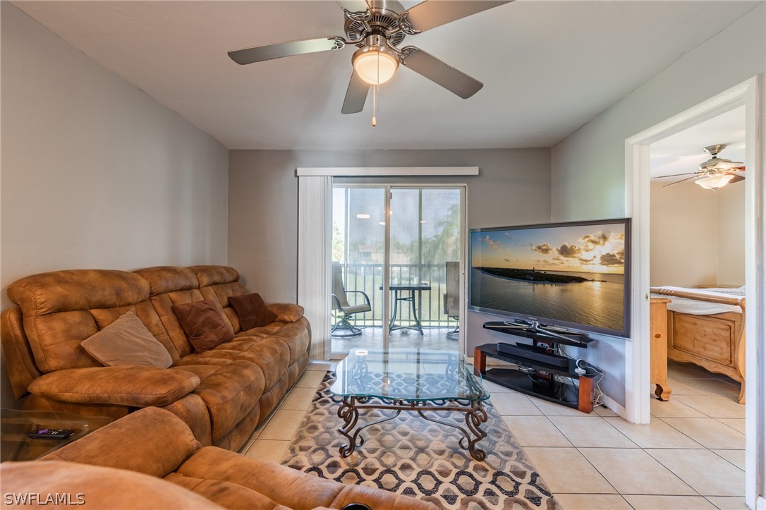 8162 Country Road, Unit 203 Fort Myers, FL 33919 - Photo 11 of 22 a living room with furniture and a flat screen tv