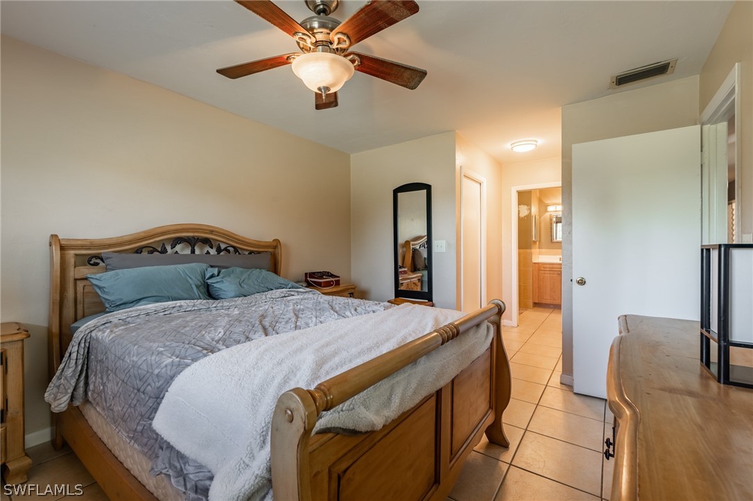 8162 Country Road, Unit 203 Fort Myers, FL 33919 - Photo 12 of 22 a bedroom with a bed and a chandelier
