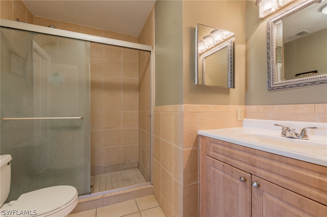 8162 Country Road, Unit 203 Fort Myers, FL 33919 - Photo 16 of 22 a bathroom with a sink a toilet and shower