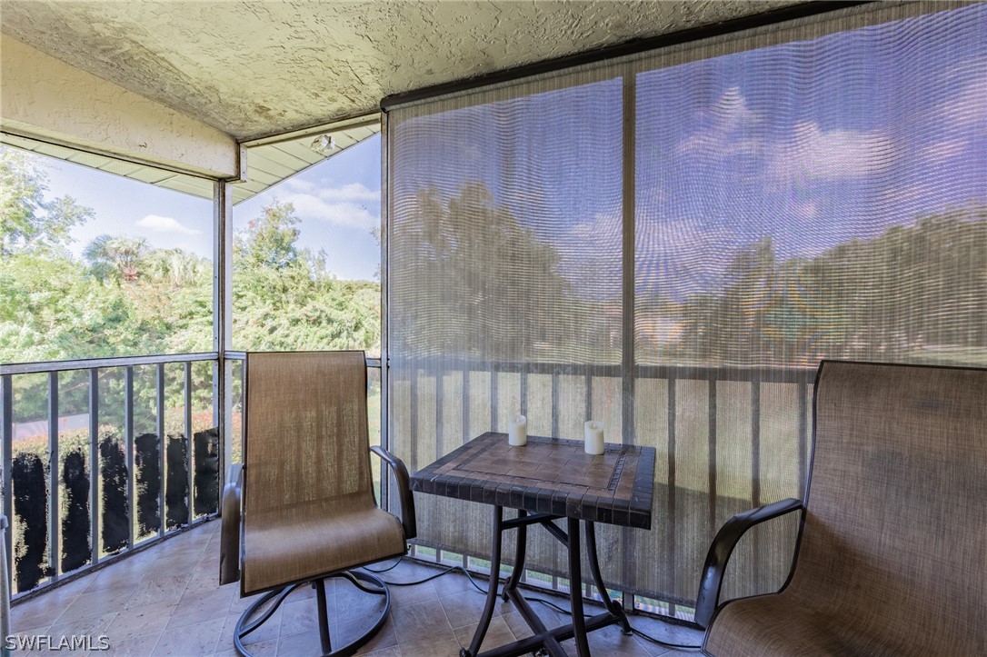 8162 Country Road, Unit 203 Fort Myers, FL 33919 - Photo 18 of 22 a view of a balcony with furniture