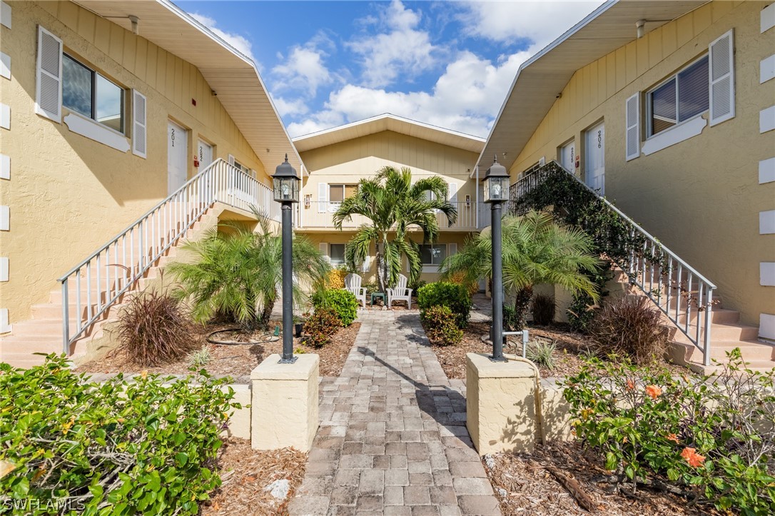 8162 Country Road, Unit 203 Fort Myers, FL 33919 - Photo 2 of 22 a view of a building with a garden