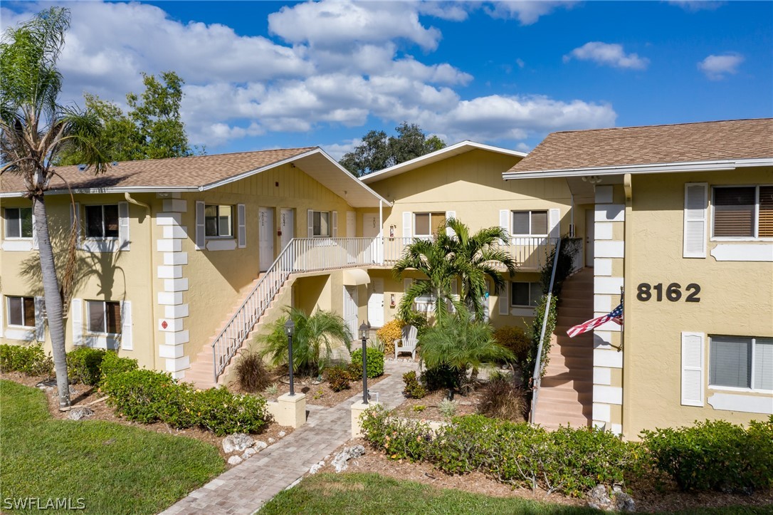 8162 Country Road, Unit 203 Fort Myers, FL 33919 - Photo 21 of 22 a front view of a house with garden