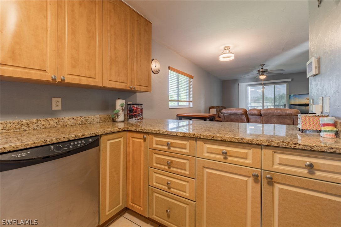8162 Country Road, Unit 203 Fort Myers, FL 33919 - Photo 6 of 22 a kitchen with granite countertop cabinets stainless steel appliances a sink and window
