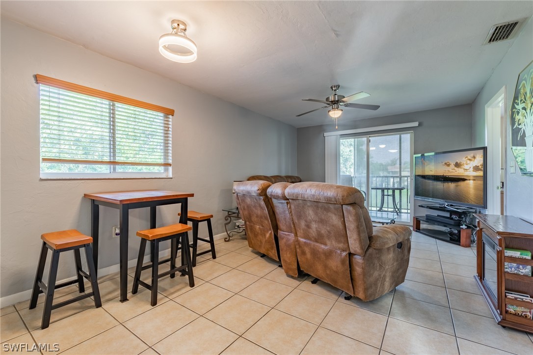 8162 Country Road, Unit 203 Fort Myers, FL 33919 - Photo 7 of 22 a living room with furniture and a flat screen tv