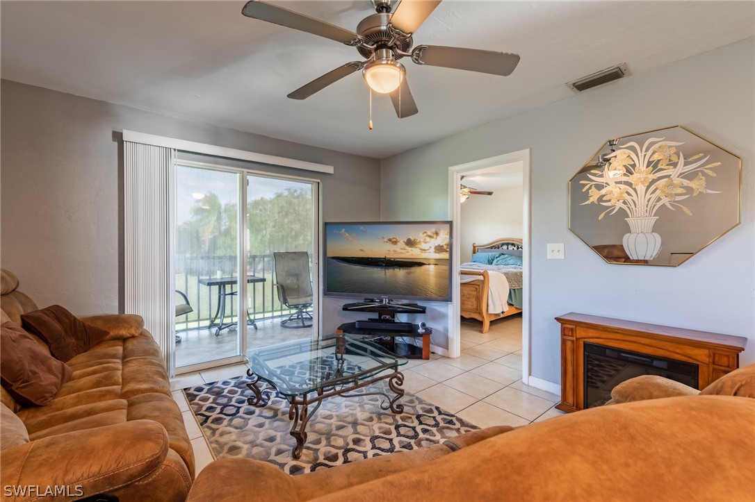 8162 Country Road, Unit 203 Fort Myers, FL 33919 - Photo 10 of 22 a living room with furniture and a flat screen tv