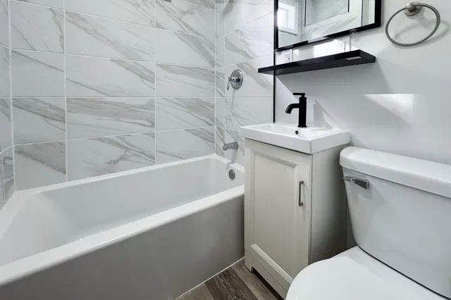 a bathroom with a sink a toilet and bathtub