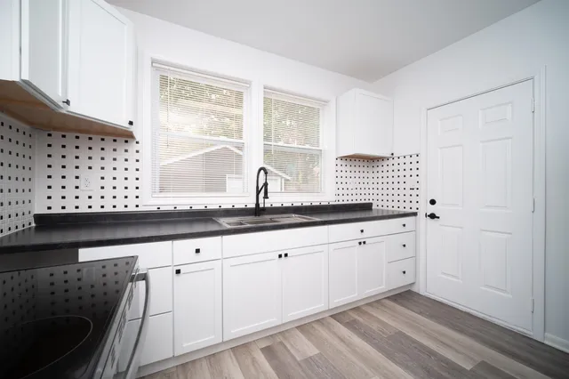 a close view of granite countertop a sink and a white cabinets