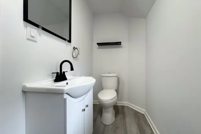 a bathroom with a sink a toilet and a mirror