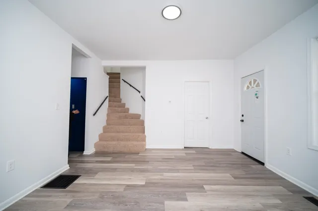 a view of entryway and hall with wooden floor