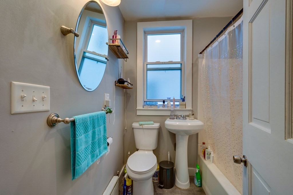 15 Hecla Street Boston, MA 02122 - Photo 20 of 33 a bathroom with a sink mirror and toilet